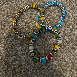NWOT set of 3 evil eye glass beaded bracelets. Yellow, blue and multicolor